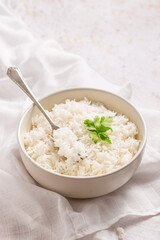 bowl of rice with a fork fluffing it