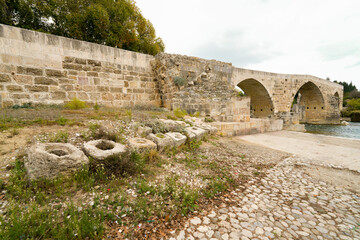 Seljuk bridge in Aspendos. The Eurymedon Bridge. Aspendos Yolu Belkis Mevkii. Turkey. Crooked bridge. Bridge over the Kopruchay (Euremedon) River near Aspendos, in Pamphylia, in southern Anatolia