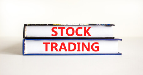 Stock trading symbol. Concept words Stock trading on beautiful books. Beautiful white table white background. Business stock trading concept. Copy space.