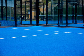 Net on a blue paddle tennis court - obrazy, fototapety, plakaty