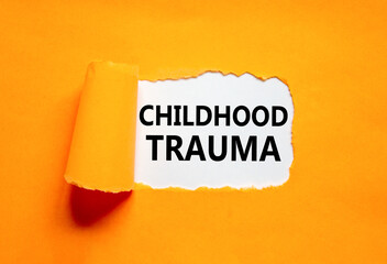 Childhood trauma symbol. Concept words Childhood trauma on beautiful white paper. Beautiful orange...