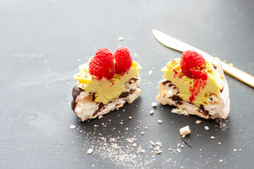 Close up of mini pavlova cakes with pistachio and chocolate filling. Desserts decorated with...