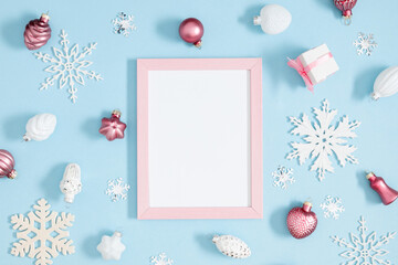 Christmas holiday composition. Photo frame, Xmas toys, decorations, gift on pastel blue background. Xmas, winter, new year concept. Flat lay, top view, copy space 