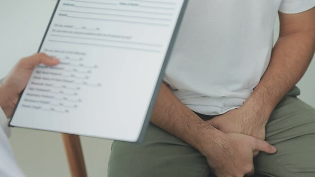 Man with benign prostatic hyperplasia being examined and consulting Asian female doctor and The doctor will ask about the patient's illness and give health advice.