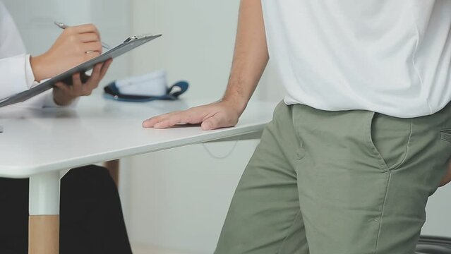 Doctor prescribes treatment to patient with bowel problems and model of unhealthy lower rectum