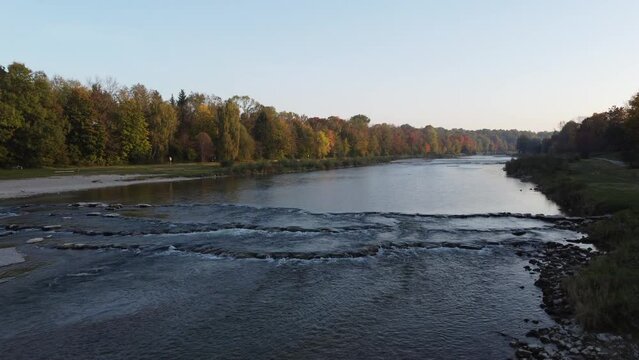 Aerial views of autumn in Munich. Isar river seen from above with colorful trees nearby