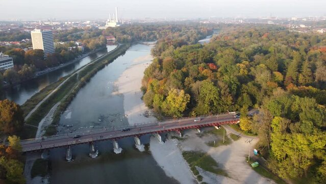 Aerial views of autumn in Munich. Isar river seen from above with colorful trees nearby
