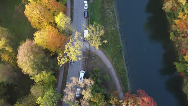 Aerial views of autumn in Munich. Isar river seen from above with colorful trees nearby