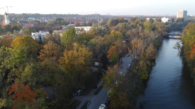Aerial views of autumn in Munich. Isar river seen from above with colorful trees nearby