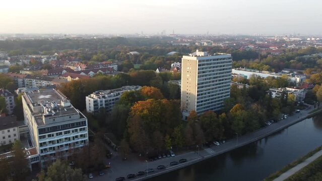 Aerial views of autumn in Munich. Isar river seen from above with colorful trees nearby