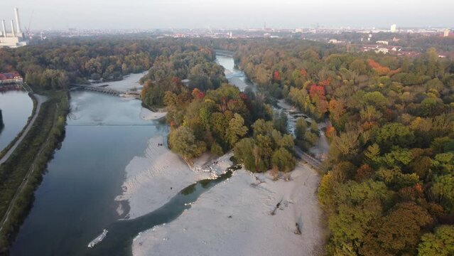 Aerial views of autumn in Munich. Isar river seen from above with colorful trees nearby