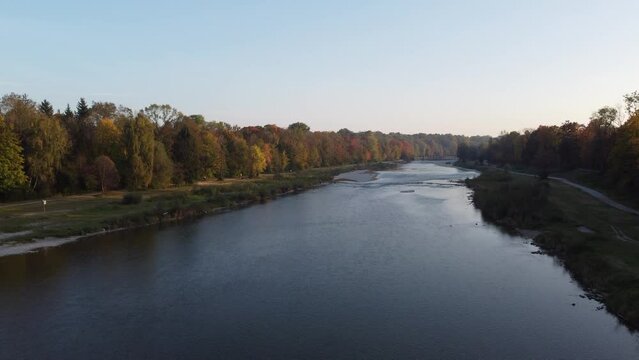 Aerial views of autumn in Munich. Isar river seen from above with colorful trees nearby