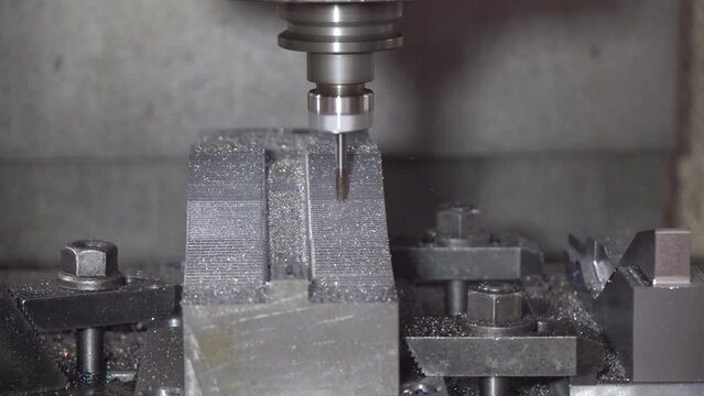 The CNC milling machine cutting press die part by solid bull end mill tool and G-code data background.