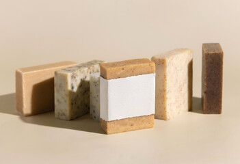 Beige and brown soap bars on light beige close up, hard shadows, packaging mockup