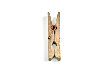 Old weathered wooden clothes peg isolated on white background