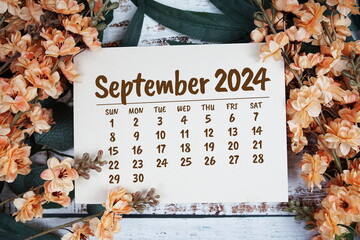September 2024 monthly calendar with flower bouquet decoration  on wooden background
