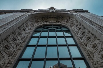 Exterior of a building with glass doors and carvings on the walls