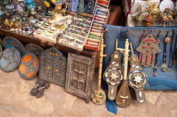 Traditional moroccan souvenirs - plate, jewels , musical instruments and interior door in Ait Ben Haddou in Morocco