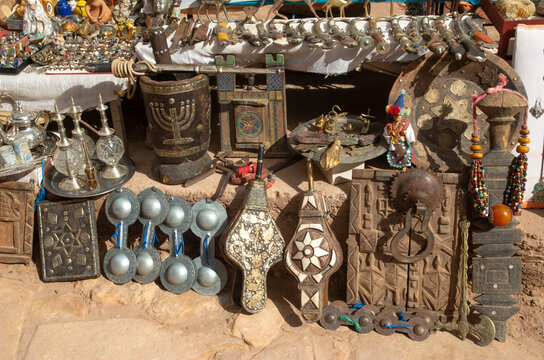 Traditional moroccan souvenirs - plate, dagger, jewels , musical instruments and interior door in Ait Ben Haddou in Morocco