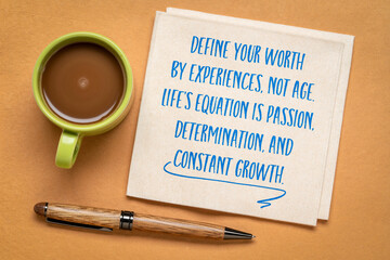 Define your worth by experience, not age. Life's equation is passion, determination, and constant growth. Inspirational note on a napkin, healthy aging and personal development concept.