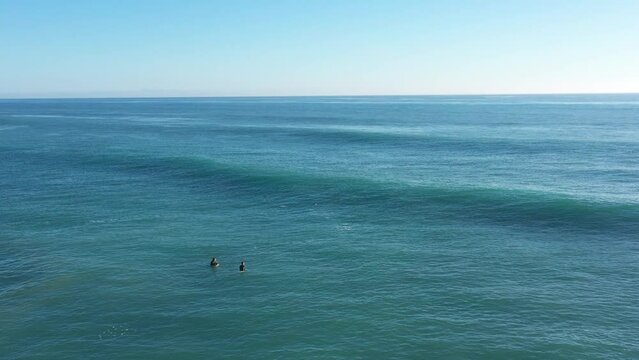 Surfer riding on a smooth nice Atlantic wave in Cadiz, Spain