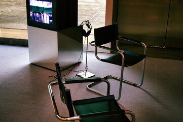 Interior of a museum, chairs, retro tv and headphones
