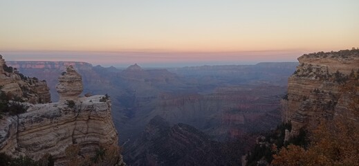 As the sun dips below the horizon, the Grand Canyon is enveloped in a captivating glow. This image, titled 