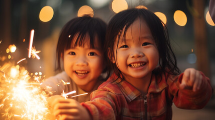 Children playing with sparklers, dressed in new clothes to celebrate the festival, Chinese new year