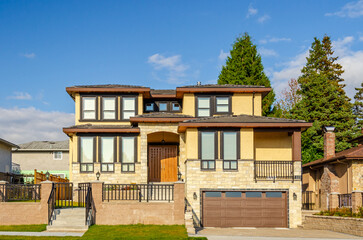 Houses in suburb at Spring in the north America. Fragment of a house with nice landscape.