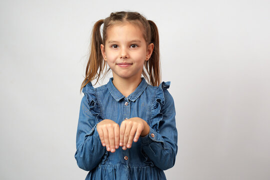 Cute little girl make bunny paws with hands,