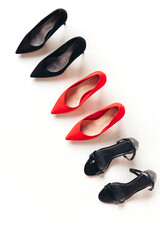 Red and black women's shoes with high heels on white background