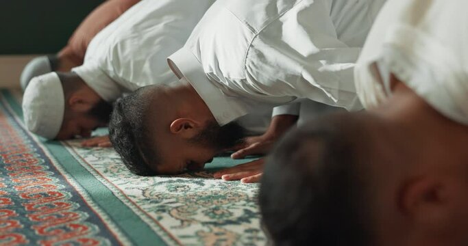 Islamic, praying and men in a Mosque for spiritual religion together as a group to worship Allah in Ramadan. Muslim, Arabic and holy people with peace or respect for gratitude, trust and hope