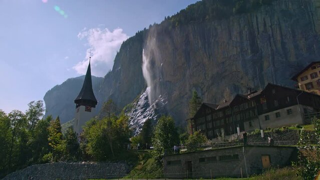 View of Staubbach Falls looking past the buildings in Lauterbrunnen, Switzerland.