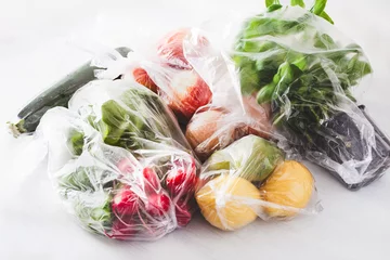 Fotobehang single use plastic waste issue. fruits and vegetables in plastic bags © Olga Miltsova