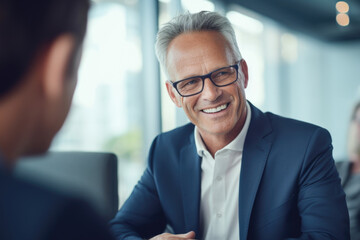Fototapeta premium Picture of man wearing suit and glasses with smile. Perfect for corporate and business-related projects
