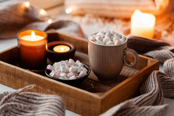 warm cozy window arrangement, winter or autumn concept, coffe, candles throw lights - obrazy, fototapety, plakaty