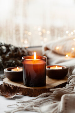 warm cozy window arrangement, winter or autumn concept, candles throw lights