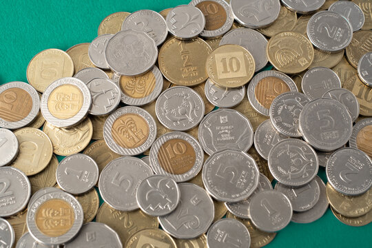 Israel's new shekel (NIS) coins in heap. Israel currency Money cash coins of various denominations and Concept financial diversity of numismatics. value of different coin nominations.