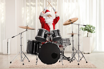 Santa claus playing drums at home in a room - obrazy, fototapety, plakaty