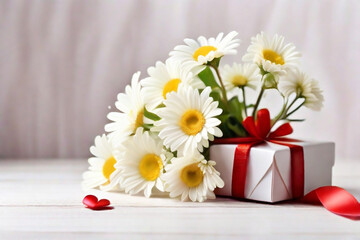A bouquet of white daisies in a gift box with red satin ribbons and red hearts on a light background.
