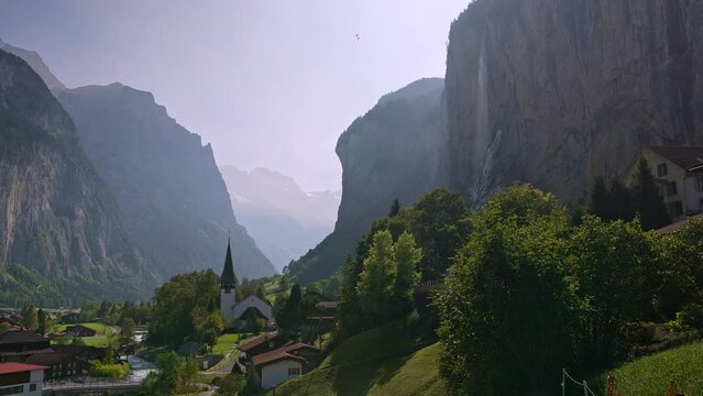View looking through the valley in Lauterbrunnen Switzerland on hazy day.