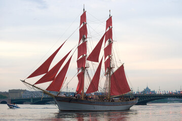 SAINT-PETERSBURG, RUSSIA - JUNE, 2018: The brig  with scarlet sails in the evening twilight. Saint Petersburg