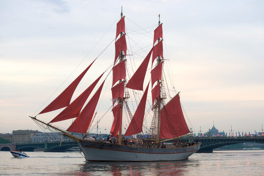 SAINT-PETERSBURG, RUSSIA - JUNE, 2018: The brig  with scarlet sails in the evening twilight. Saint Petersburg