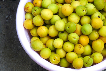 Fresh yellow  plums, light green plums background. - 678293315