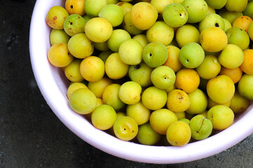 Fresh yellow  plums, light green plums background. - 678293340