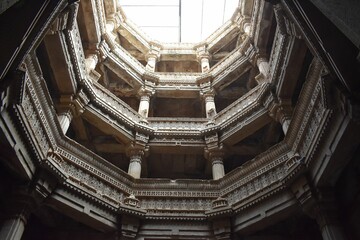 Low angle view of the interior of the famous Adalaj stepwell landmark in Gujarat, India - obrazy, fototapety, plakaty