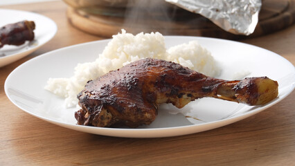 Close-up shot Barbecued Chicken Leg with Rice on Plate.