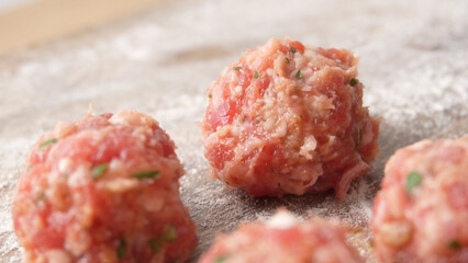 Formed meatball on a board with flour. Close-up shot with shallow dof.