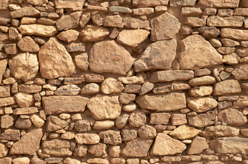 Colorful ancient stone wall closeup.