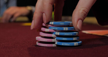 Poker chips on the table. Close-up of hands.